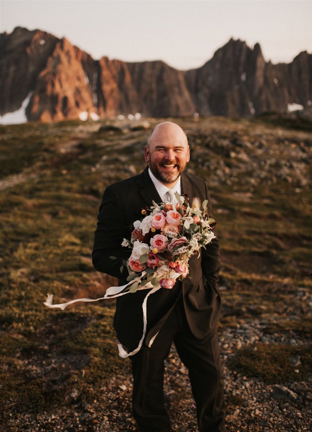 Royce celebrating in an alpine basin at sunset